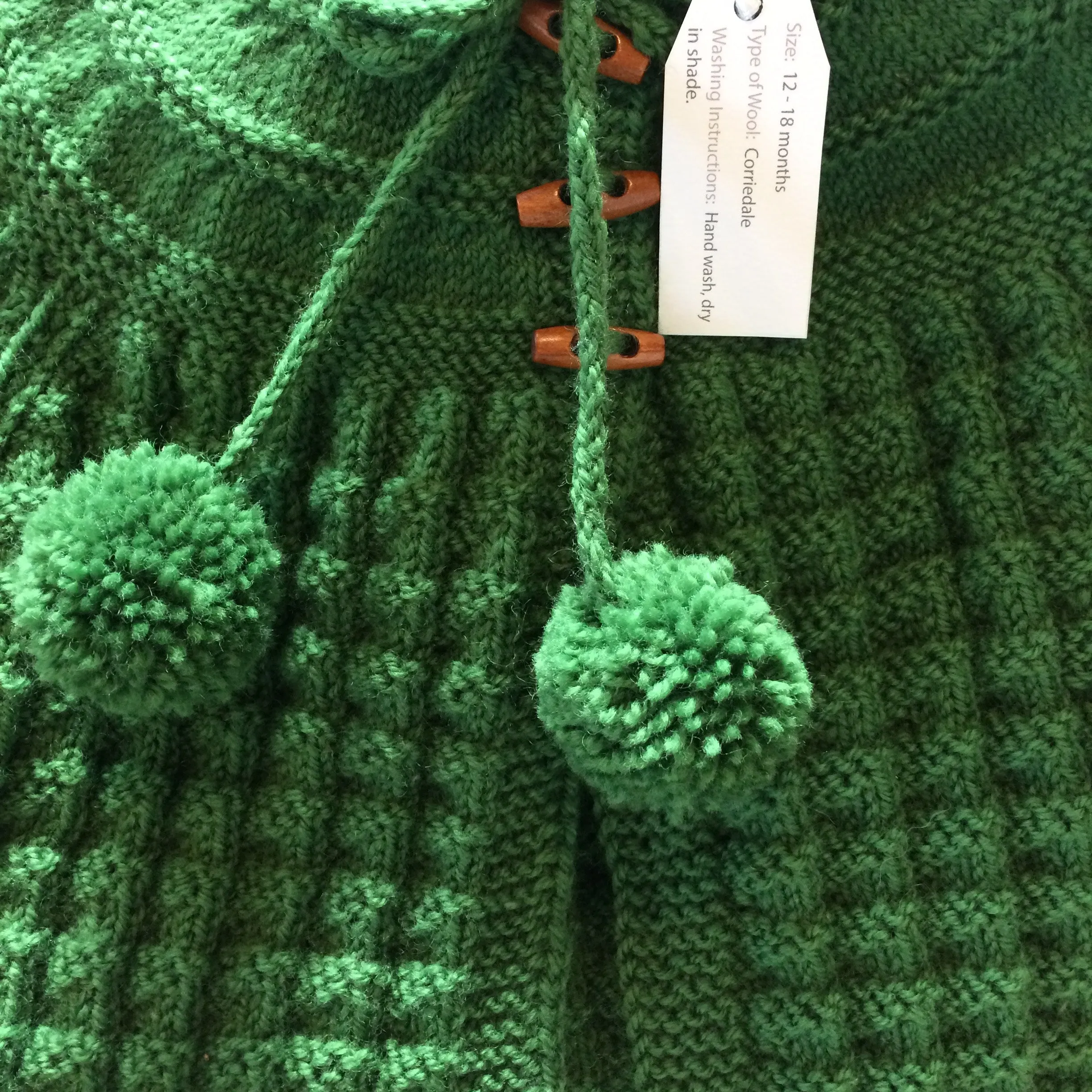 Hand Knitted Hooded Jacket with Pom Poms