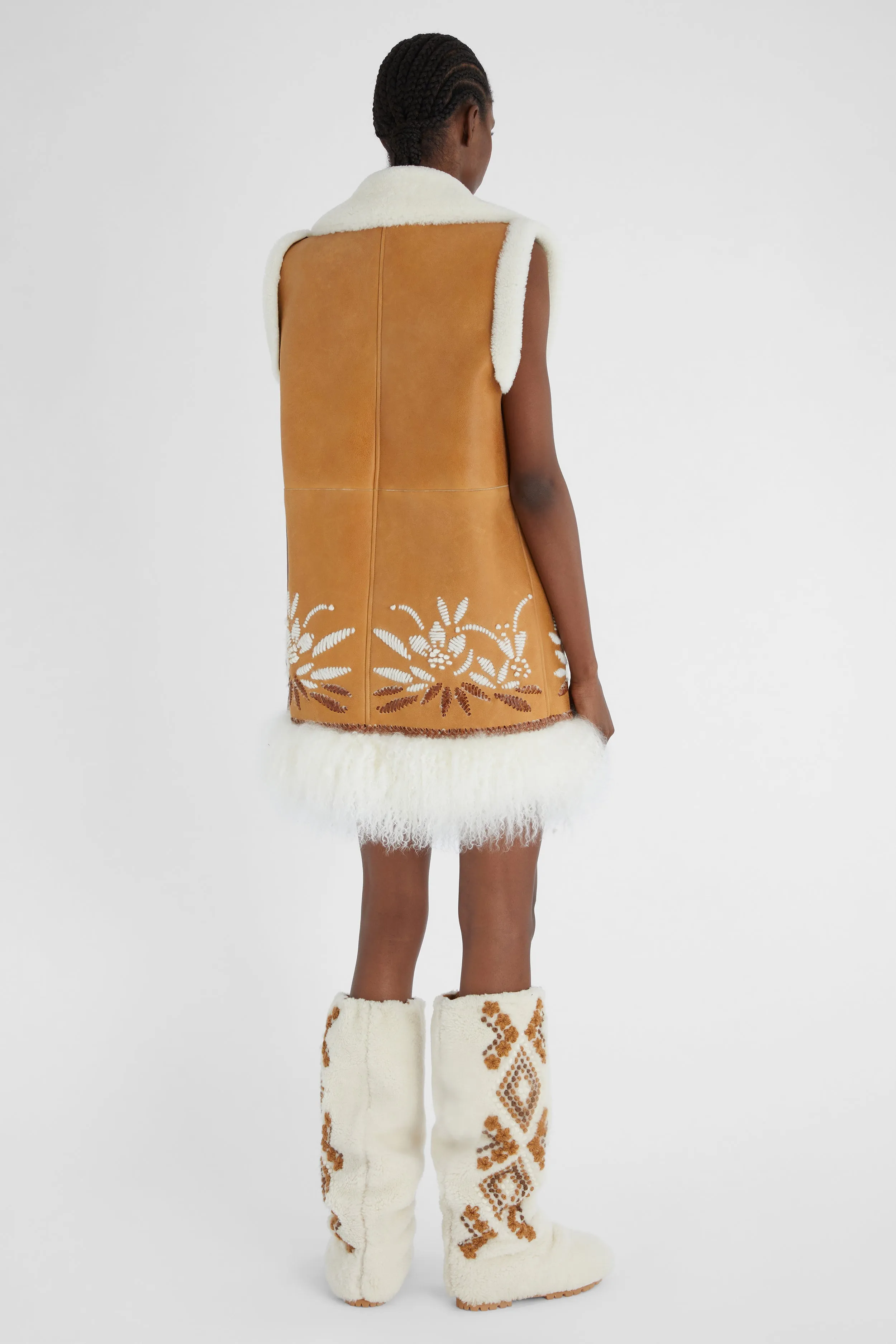 Shearling long waistcoat with handmade embroidery and fur on the bottom